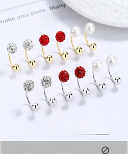 Macro view of 925 silver pearl and crystal ball screw earrings in gold and silver