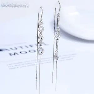 Detail view of 925 silver long threader earrings with 520 and 1314 numeric charms