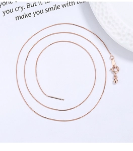 Close-up of rose gold 925 sterling silver box chain with adjustable slider and spring clasp