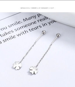 Detail view of 925 sterling silver four-leaf clover long tassel threader earrings