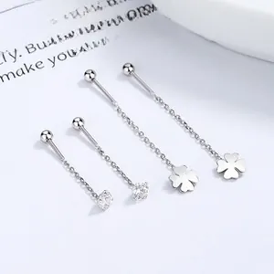 Macro view of 925 silver long tassel earrings with clover and zircon details
