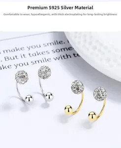Detail of S925 silver U-shaped stud earrings set with crystal pavé balls in gold and silver