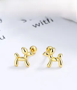 Detailed macro view of 925 silver balloon dog stud earrings with golden plating finish