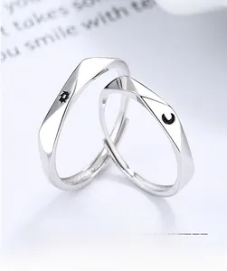Macro shot of 925 sterling silver couple rings with sun and moon engraved patterns