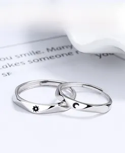 Close-up of S925 silver sun and moon couple rings with polished finish and open design