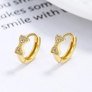 Pair of gold 925 sterling silver bow huggie hoop earrings with sparkling crystal pavé