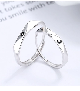 Detailed macro view of S925 silver sun and moon couple rings with adjustable bands