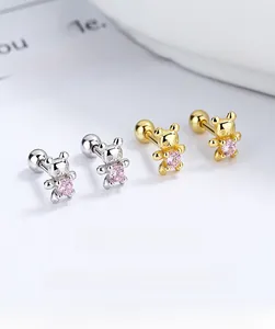 Macro detail of bear-shaped stud earrings with pink zircon and screw-back closure
