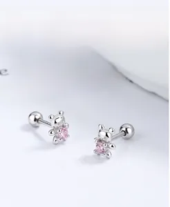 Macro shot of 925 sterling silver bear studs with pink zircon and screw-back detail