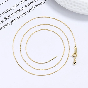 925 silver gold-plated box chain necklace with needle end and spring clasp on white background