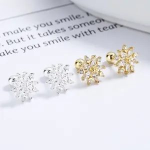 Close-up of snowflake stud earrings with sparkling cubic zirconia and ball back design