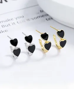 Detailed view of S925 silver double heart enamel studs in gold and silver finishes