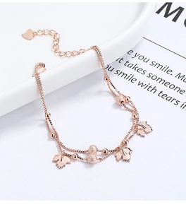 Detailed macro view of rose gold maple leaf charms on a multi-layer 925 silver chain