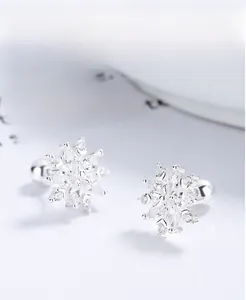 Macro view of S925 sterling silver snowflake stud earrings with sparkling cubic zirconia