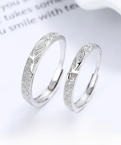 Detail of 925 sterling silver couple rings with deer antler design and matte finish