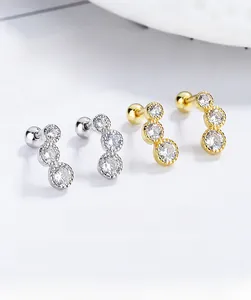Macro shot of 925 silver screw back earrings featuring three graduated round cubic zirconia