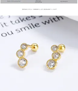 Close-up of S925 sterling silver gold curved three-diamond stud with screw back