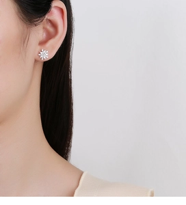 Macro detail of 925 sterling silver snowflake stud earrings with sparkling cubic zirconia