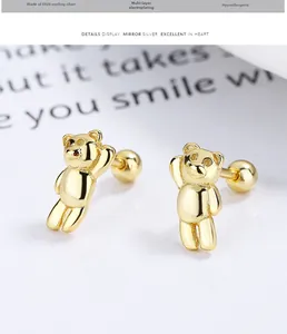 Macro detail of gold plated 925 silver bear studs with secure screw ball backings
