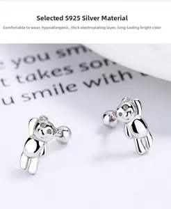 Macro shot of 925 sterling silver bear stud earrings with polished finish on white background
