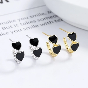 925 silver stud earrings with overlapping black enamel hearts in gold and silver finishes