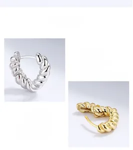 Detailed view of silver and gold twisted rope hoop earrings with S925 hallmark