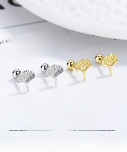 Detailed macro view of 925 sterling silver ginkgo leaf stud earrings in gold and silver