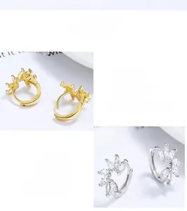 Détail du poinçon argent S925 et zircones marquise sur les boucles d'oreilles couronne