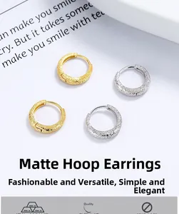 Detailed view of matte 925 sterling silver hoop earrings in gold and silver finishes