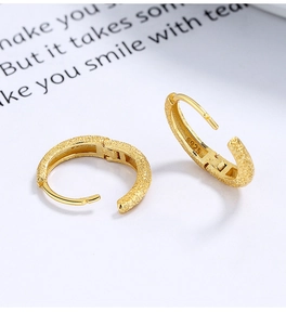 Macro detail of gold frosted S925 sterling silver hoop earrings with matte texture