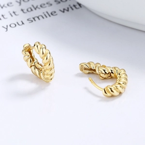 925 silver gold-plated twisted hoop earrings with engraved S925 hallmark on white surface