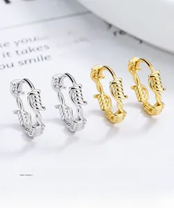 Detailed view of silver and gold twisted rope hoop earrings with a textured vintage design