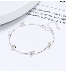 Close-up of 925 sterling silver bean knot bracelet featuring polished metal texture