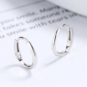 Polished S925 sterling silver Mobius twist hoop earrings on a clean white surface