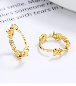 Detailed shot of gold plated S925 sterling silver hoop earrings with wire thorn design