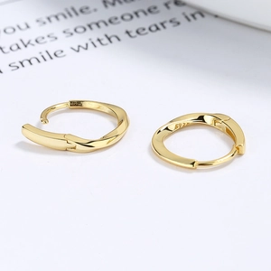 Polished S925 sterling silver Mobius hoop earrings in gold with a twisted minimalist design