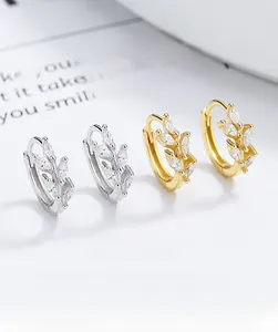 Detail of 925 sterling silver leaf hoop earrings with marquise-cut zircons in gold and silver