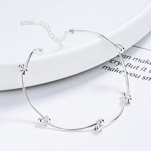 925 sterling silver beaded knot bracelet with adjustable chain on white ceramic plate