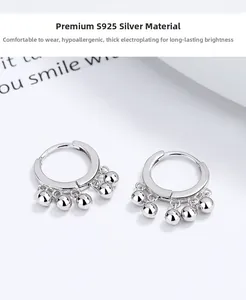 Detailed macro shot of S925 sterling silver hoop earrings with five metal beads