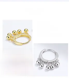 Detailed close-up showing S925 sterling silver stamp and five ball tassels on hoop earrings