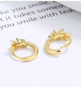 Detailed view of gold plated S925 sterling silver leaf earrings with cubic zirconia stones