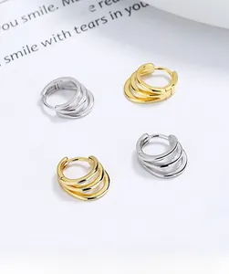 Detail view of S925 sterling silver triple layer hoop earrings in gold and silver finish