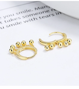 Close-up of gold-plated S925 sterling silver hoop earrings with five hanging beads