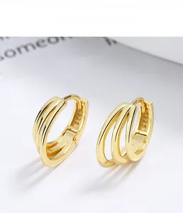 Macro view of triple-layered 925 sterling silver earrings with gold plating and S925 hallmark