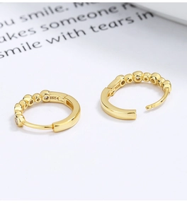 Detailed close-up showing the S925 silver hallmark and gold-plated cubic zirconia earrings