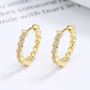 925 sterling silver twist hoop earrings with pavé crystals in a golden polished finish