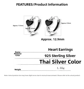 Detail of vintage 925 sterling silver heart hoop earrings with black heart charms