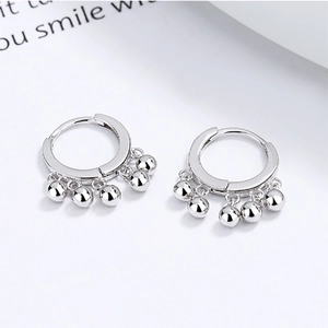 925 sterling silver hoop earrings featuring hanging round beads on a clean white backdrop