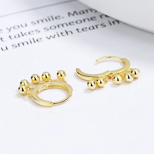 925 Sterling Silver gold-plated hoop earrings with polished beads on white background