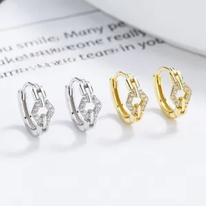 Close-up of geometric S925 silver C-shape ear cuffs with micro-pave cubic zirconia